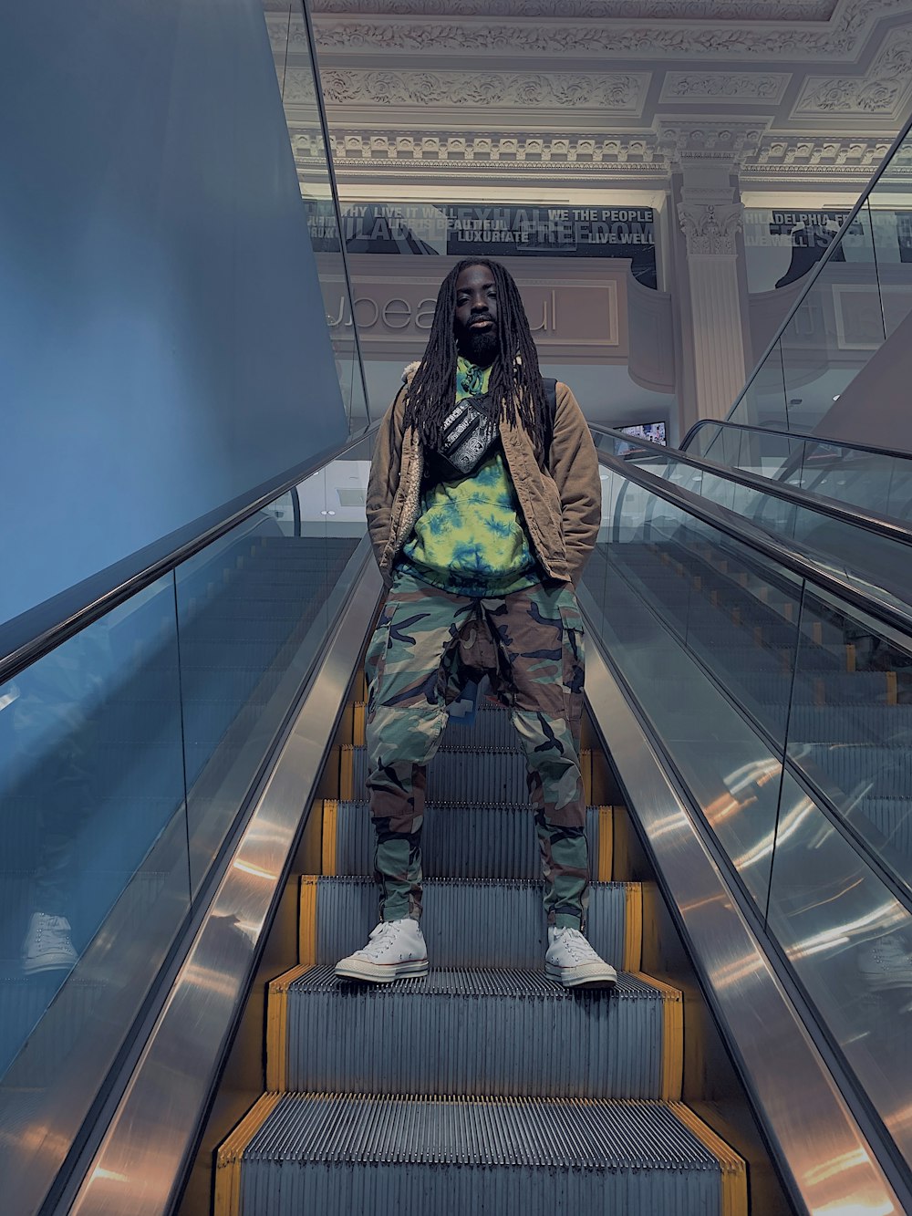 man standing in an escalator