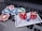 A set of red dice and poker chips are placed on top of a credit card, which is situated on a laptop keyboard. The poker chips are in various colors, including blue, green, red, and white.