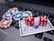 A set of red dice and poker chips are placed on top of a credit card, which is situated on a laptop keyboard. The poker chips are in various colors, including blue, green, red, and white.