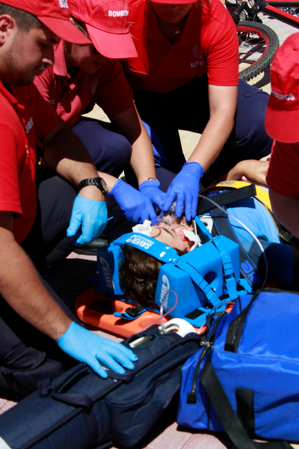 people performing first aid medical care to an injured man