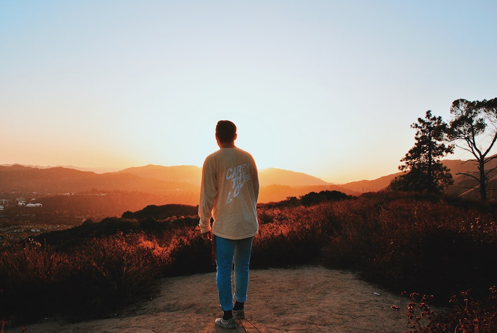 man standing on brown field