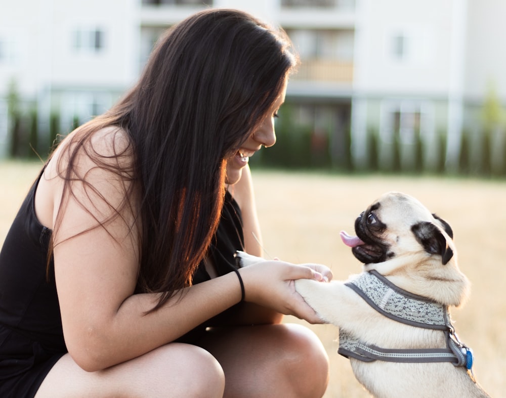 woman holding fawn pug