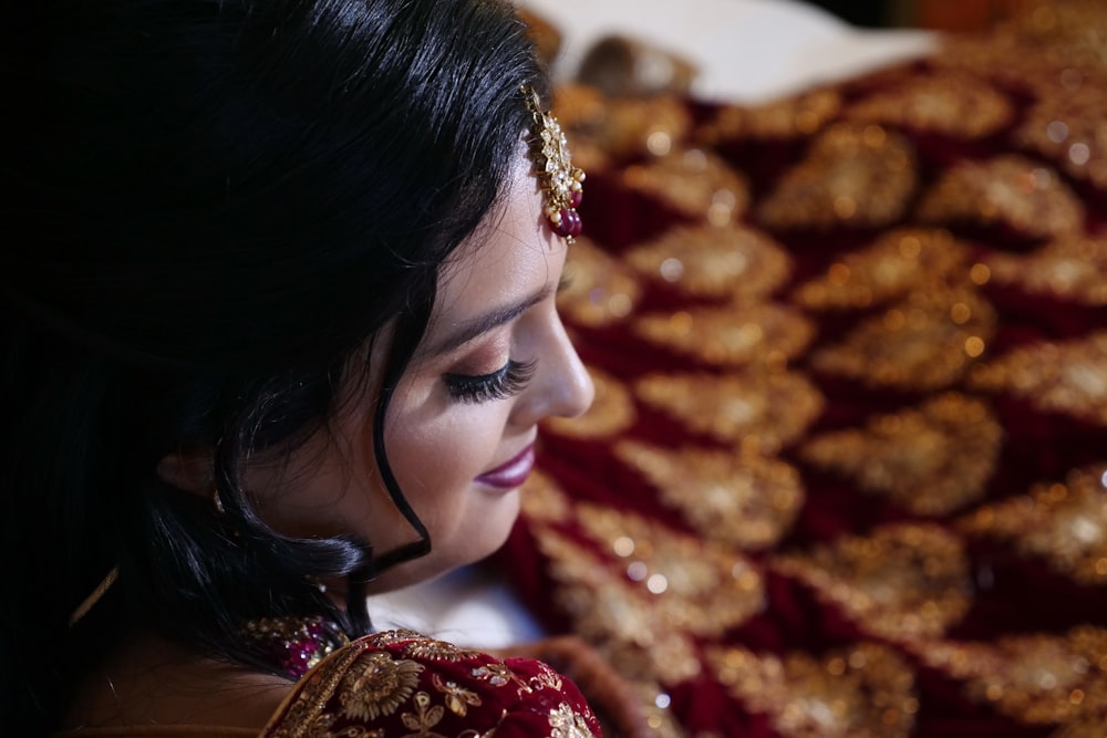 woman wearing gold and red floral sari dress