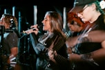 A lively group of musicians performing on stage with retro instruments.