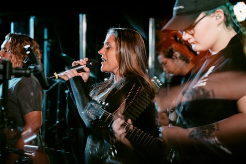 A diverse group of artists performing on stage.