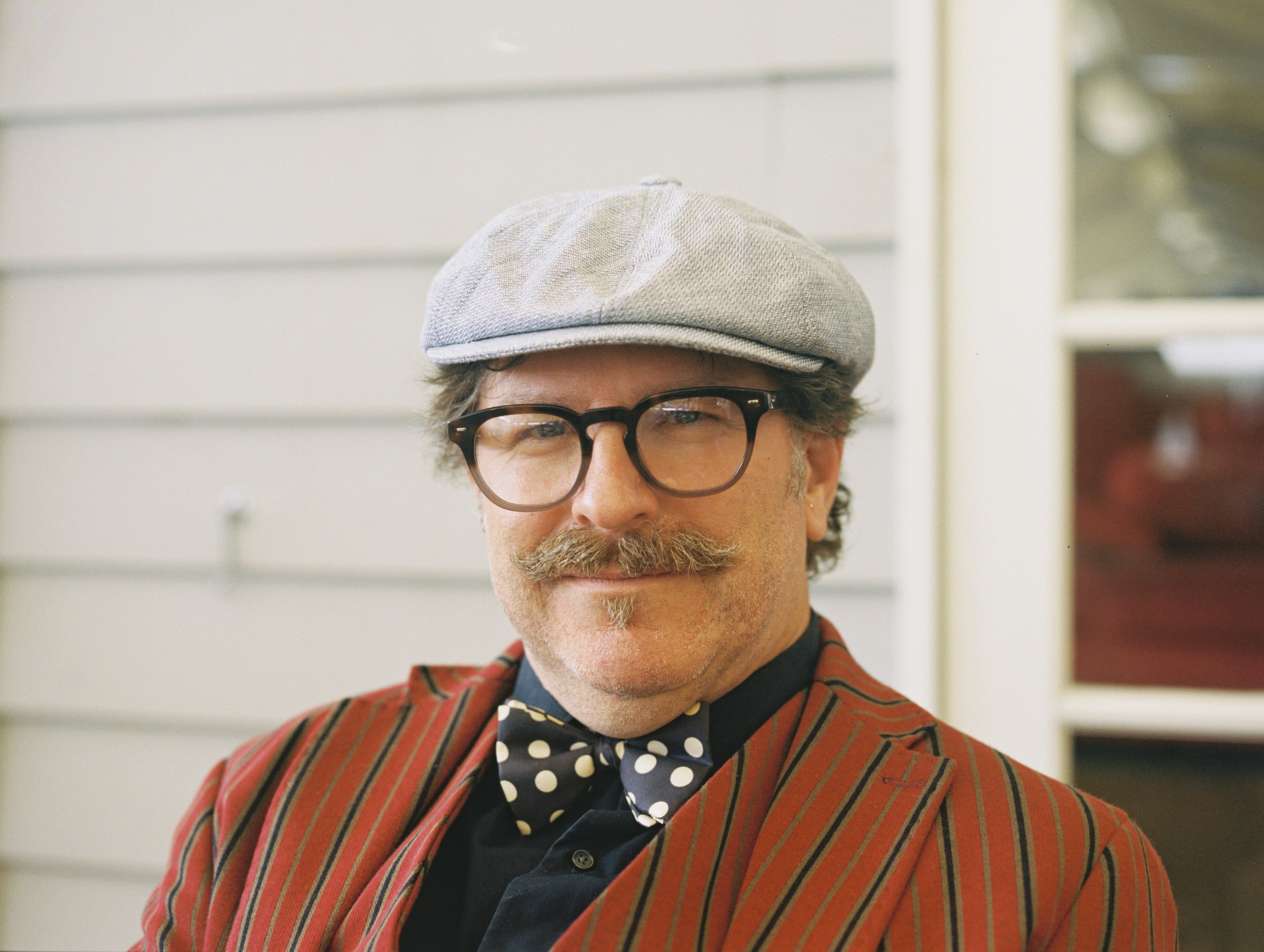 man wearing white flat cap distinguished teams background