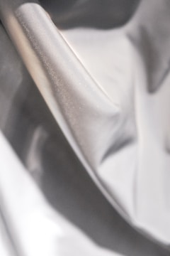 A close-up of luxurious fabric draped elegantly on a mannequin.