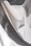 A close-up view of smooth, flowing fabric with a soft texture. The material appears to be draping gracefully, creating gentle, undulating curves.