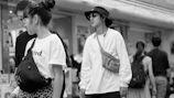 A vibrant street scene featuring young adults in stylish streetwear.