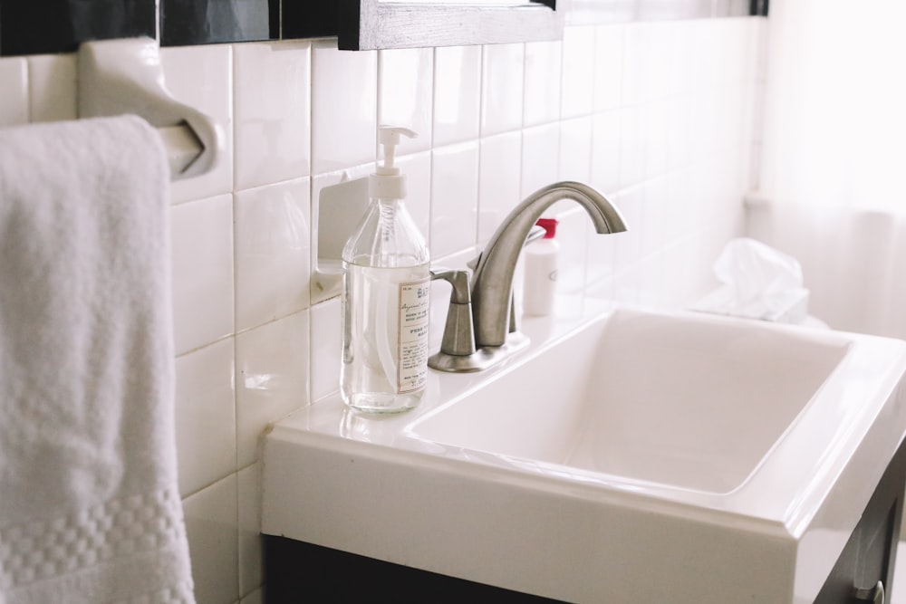 white pump bottle on white sink