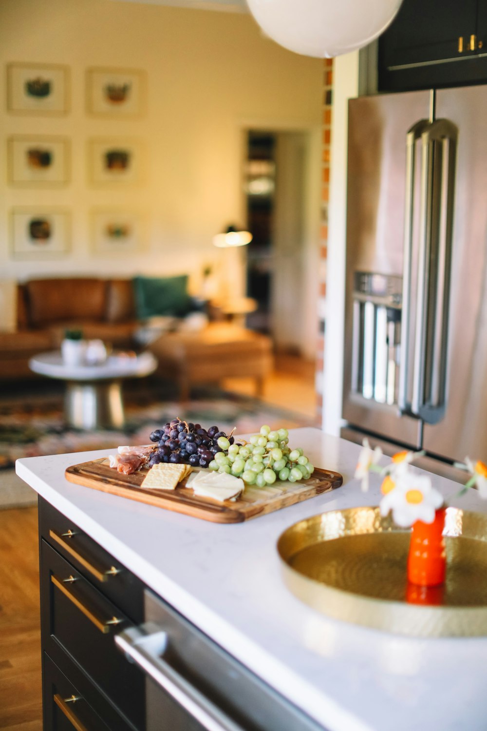 wooden tray of grapes, cheese and crackers