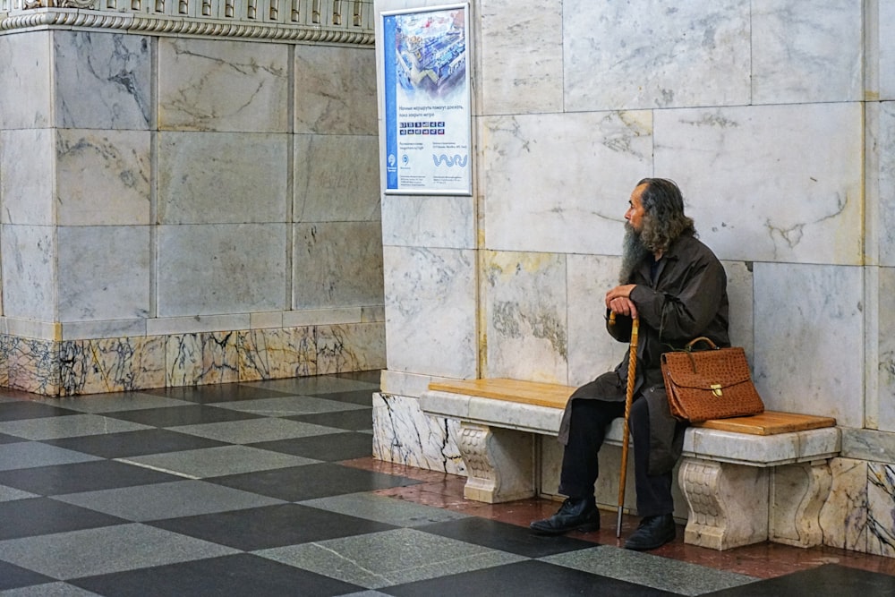 Man wearing black trench coat and black pants sitting on bench photo – Free  Grey Image on Unsplash