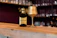 Elegant wine bottle with a glass on a dark matte surface, highlighting luxury.