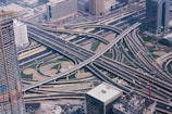 An aerial view of a complex highway interchange bustling with traffic.