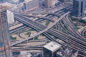 An aerial view of a complex highway interchange bustling with traffic.