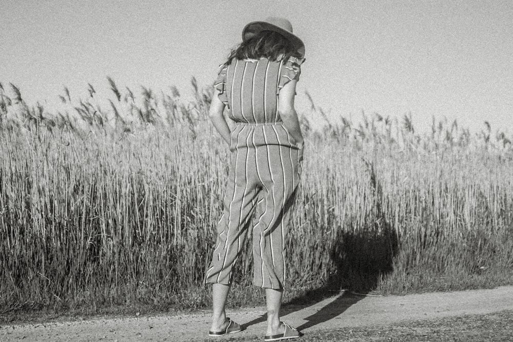 greyscale photo of standing woman