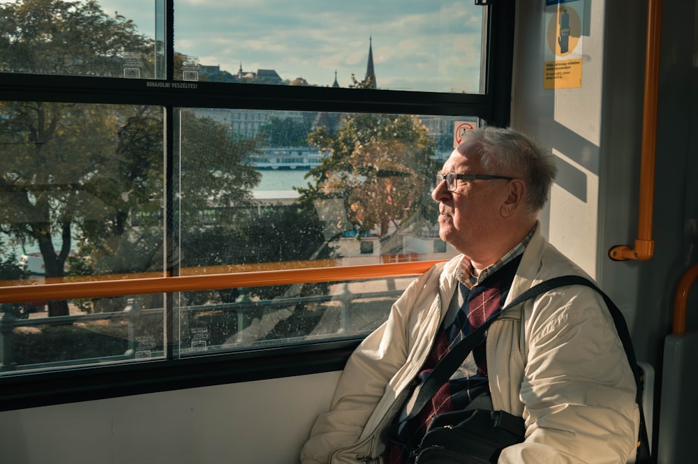 man sitting beside window