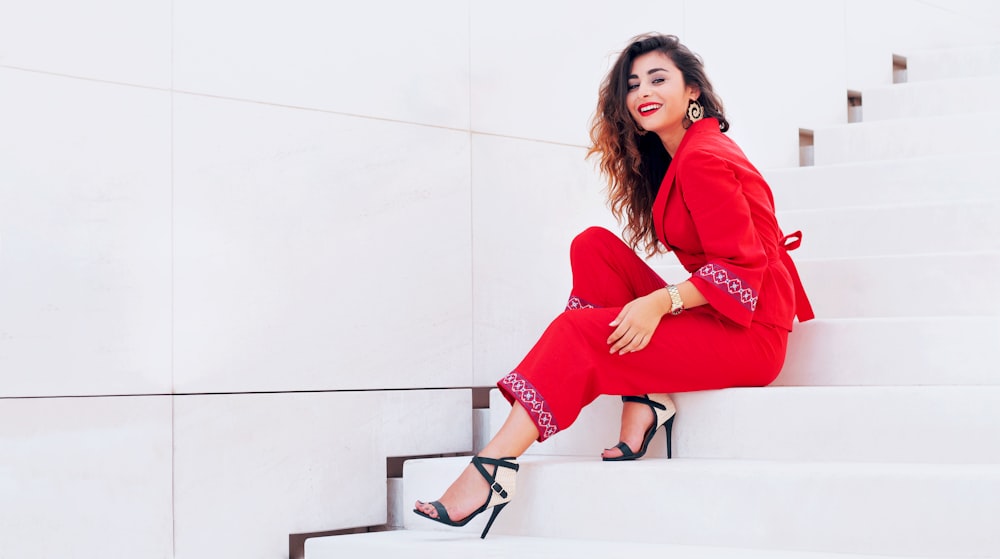 smiling woman sits on stairway