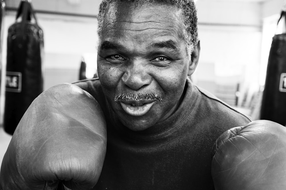 smiling man wearing boxing gloves