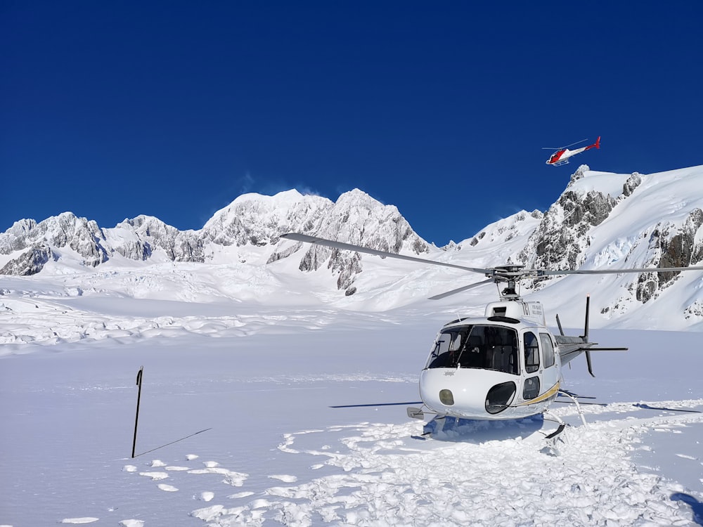 white helicopter on ice field