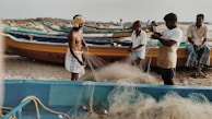 A group of small-scale fishermen preparing their nets.