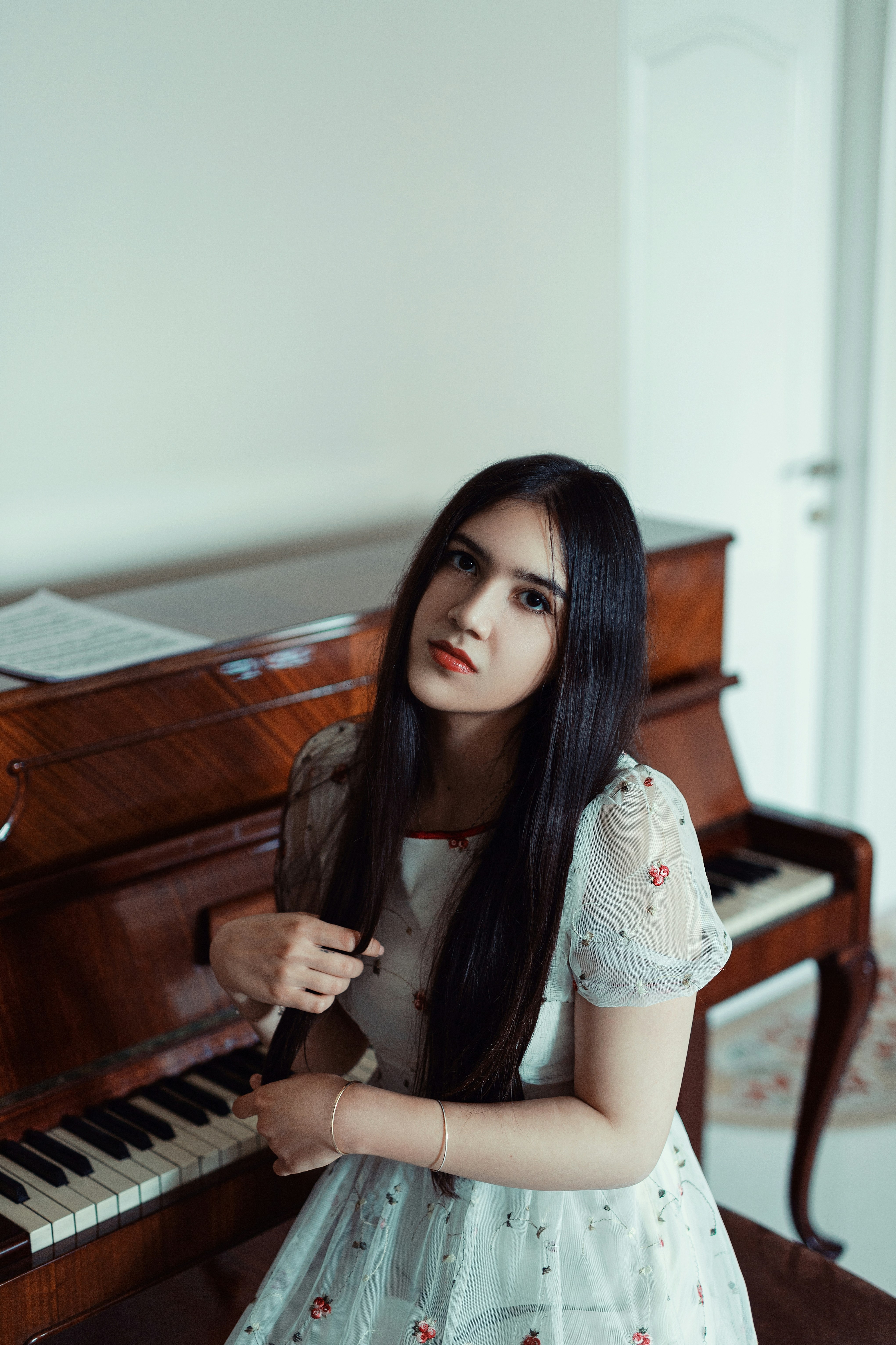Woman Sitting By The Piano Photo Free Grand Piano Image On Unsplash