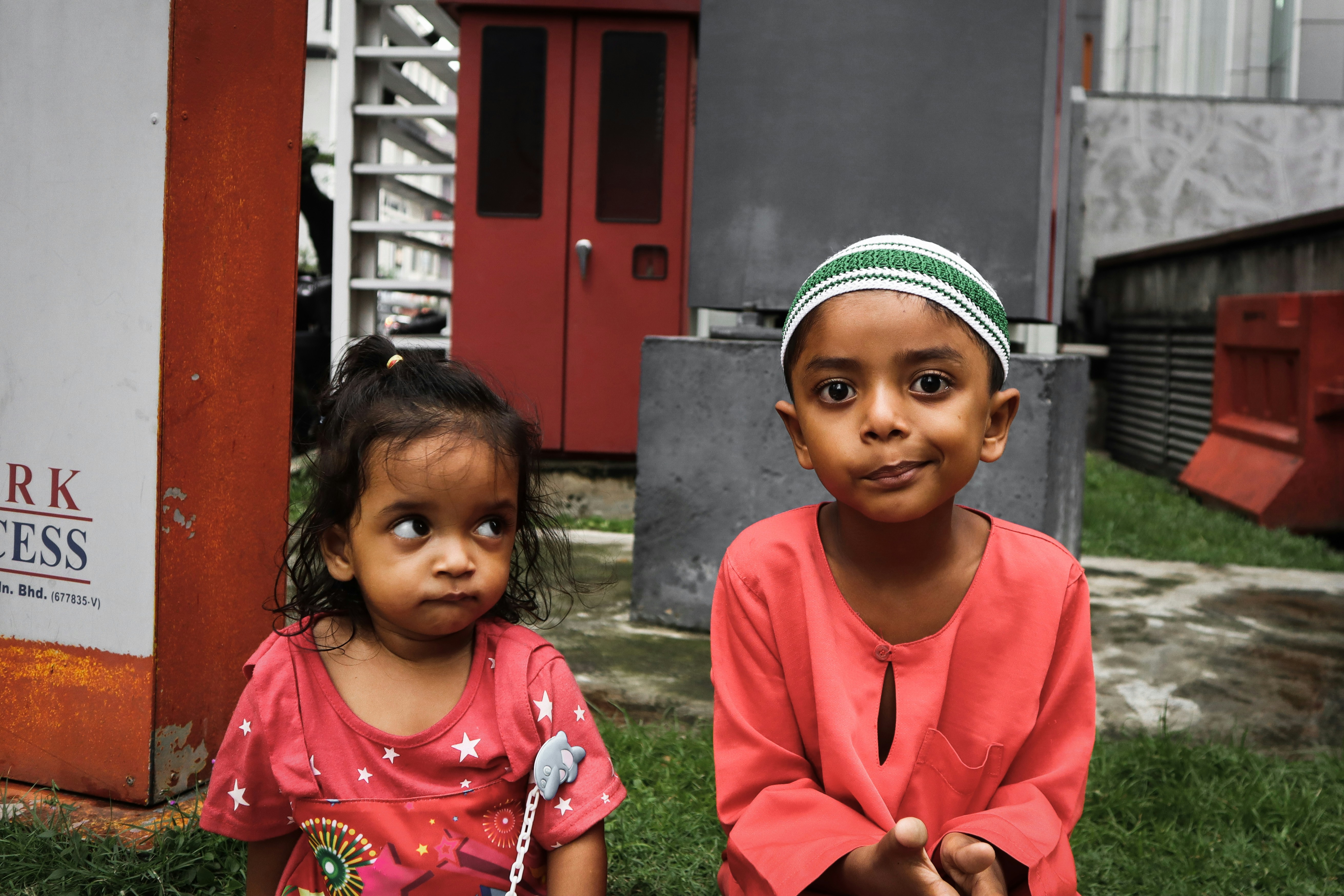 The boy is annoyed, the little girl got curious. 