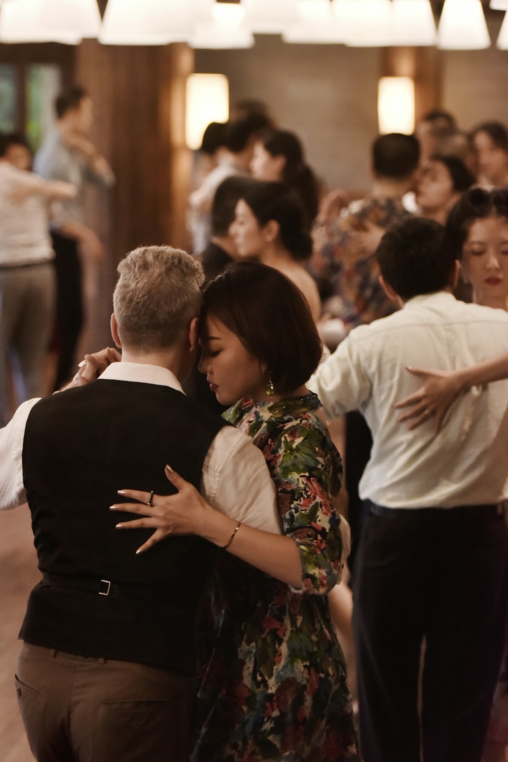 shallow focus photo of man and woman dancing