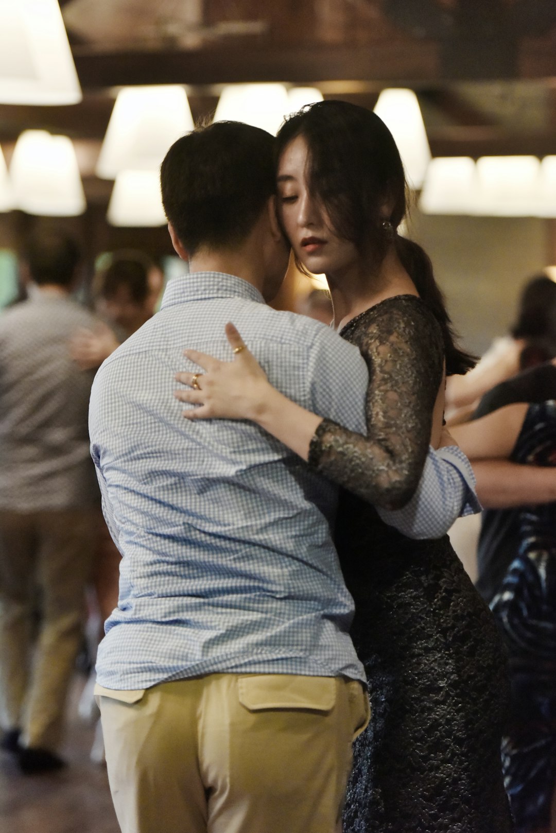 man dancing with a woman inside a lighted room