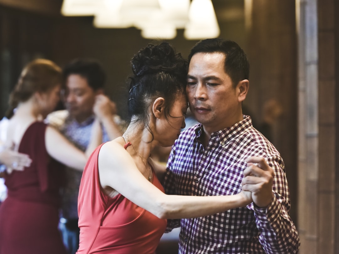 shallow focus photo of man and woman dancing