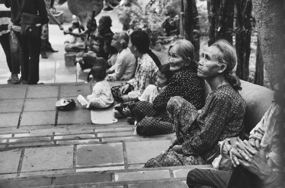 grayscale photography of woman siting on ground