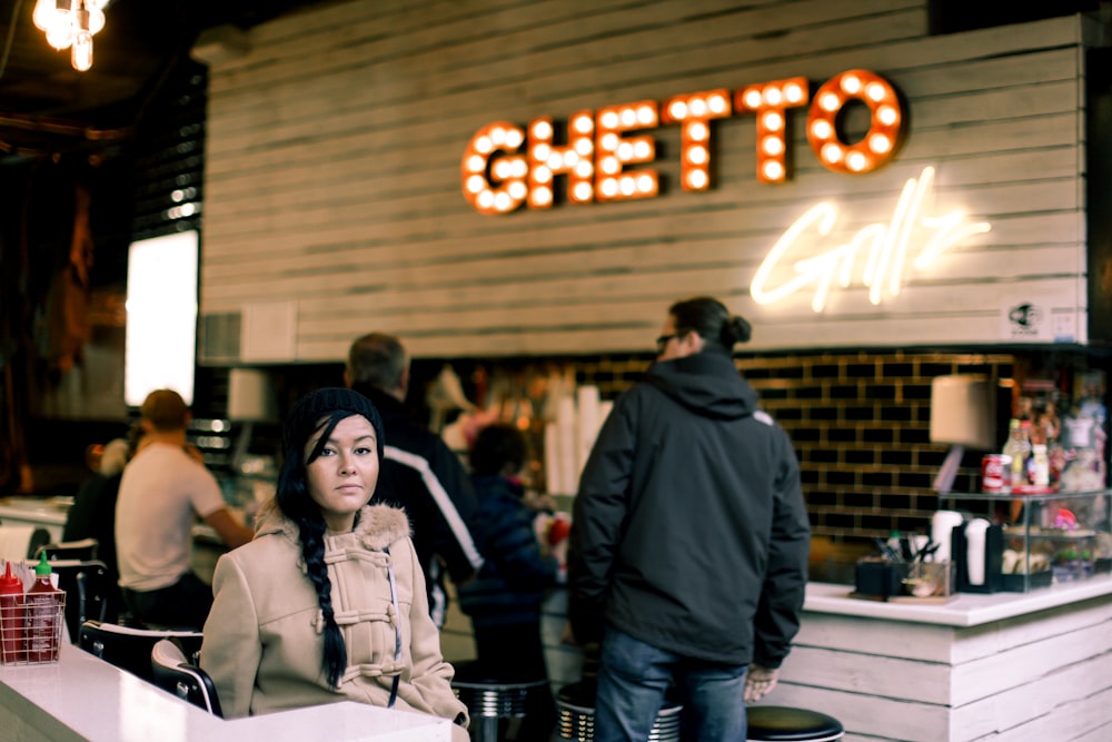 shallow focus photo of woman in brown jacket