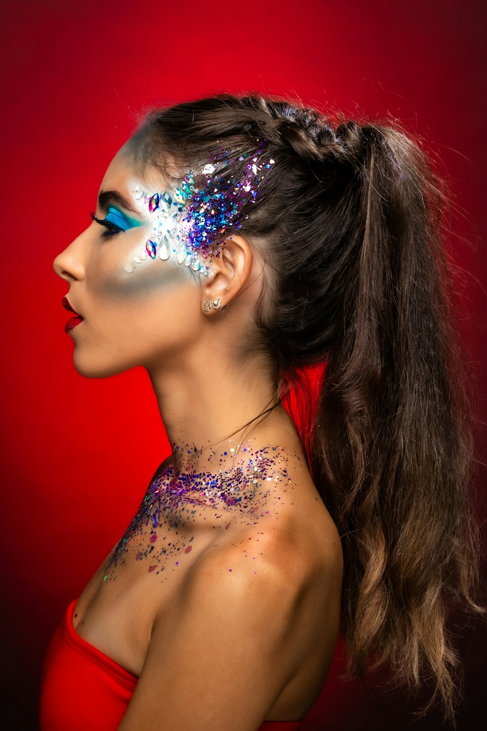 a woman with glitter on her face and neck