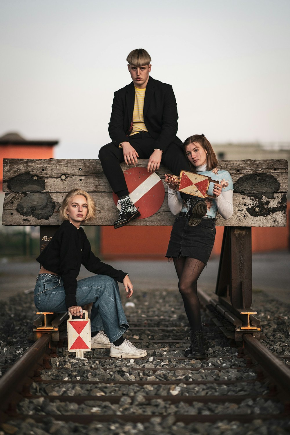 man and women sitting and standing in front of brown rack