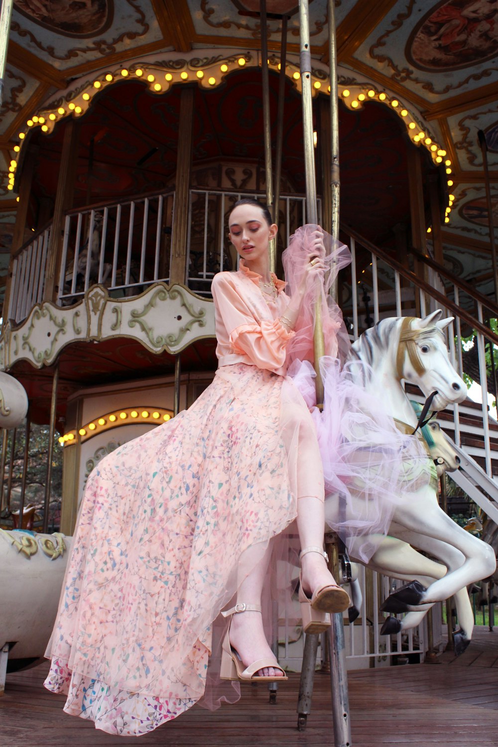 white and pink carousel horse