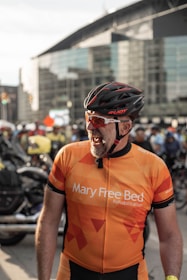A cyclist smiling while riding a city bike equipped with an ihs boosters inc. booster on a sunny day.