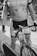A person wearing a cycling jersey and bib shorts is holding a bicycle. The cycling jersey displays the words 'Mary Free Bed Rehabilitation'. The bicycle has a mounted number 1033. The setting appears to be an event, possibly a race or a group ride.
