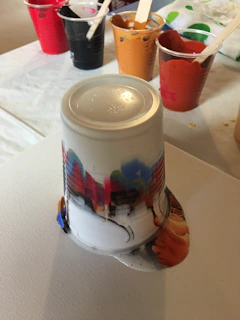 An artistic shot of the printing process showing colorful inks being applied on plastic cups.