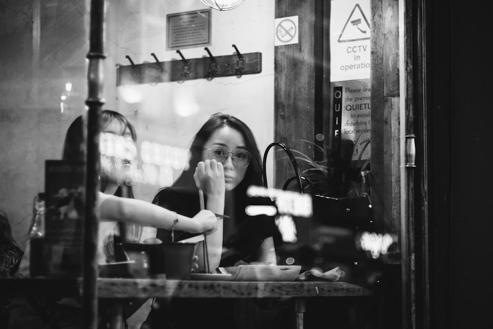 women behind glass panels