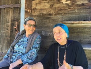 A pair of women enjoying a relaxed conversation on a city bench