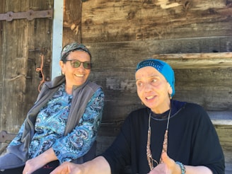 A pair of women enjoying a relaxed conversation on a city bench