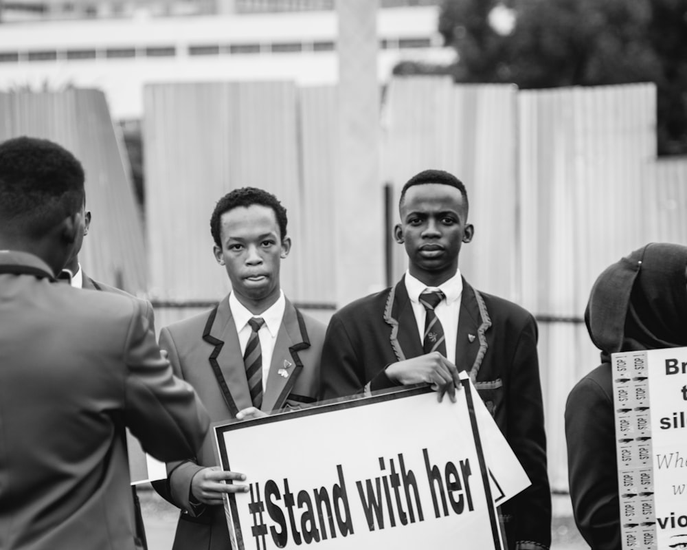 grayscale photography of man holding banner