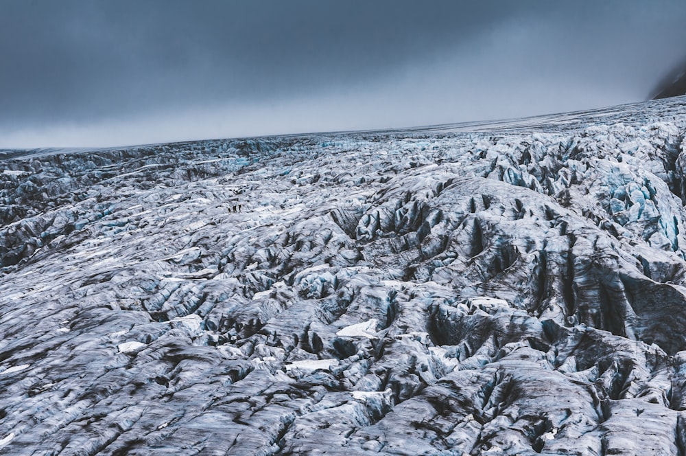 snow covered mountain under cloudy sky during daytime