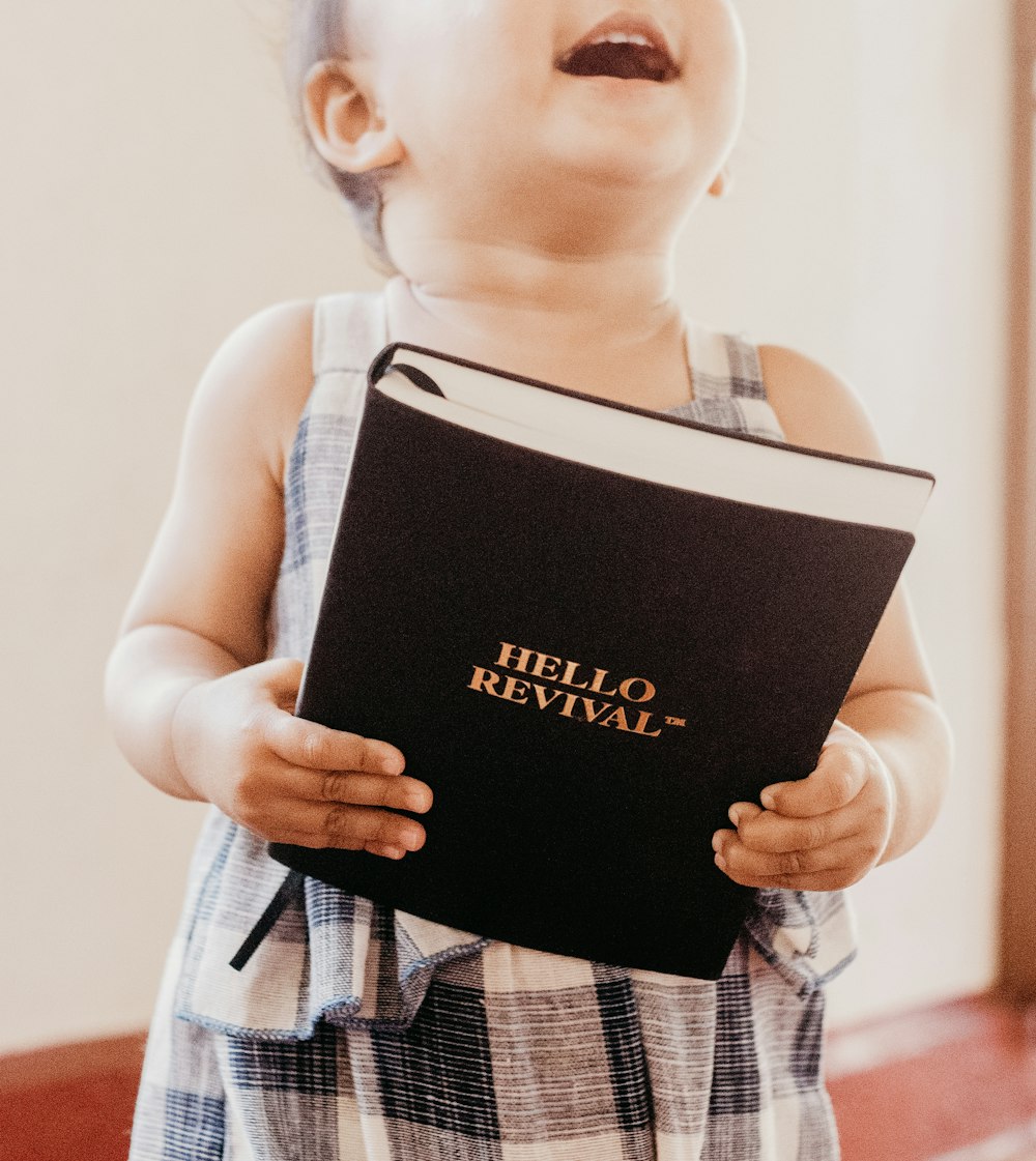 girl holding Hello Revival book