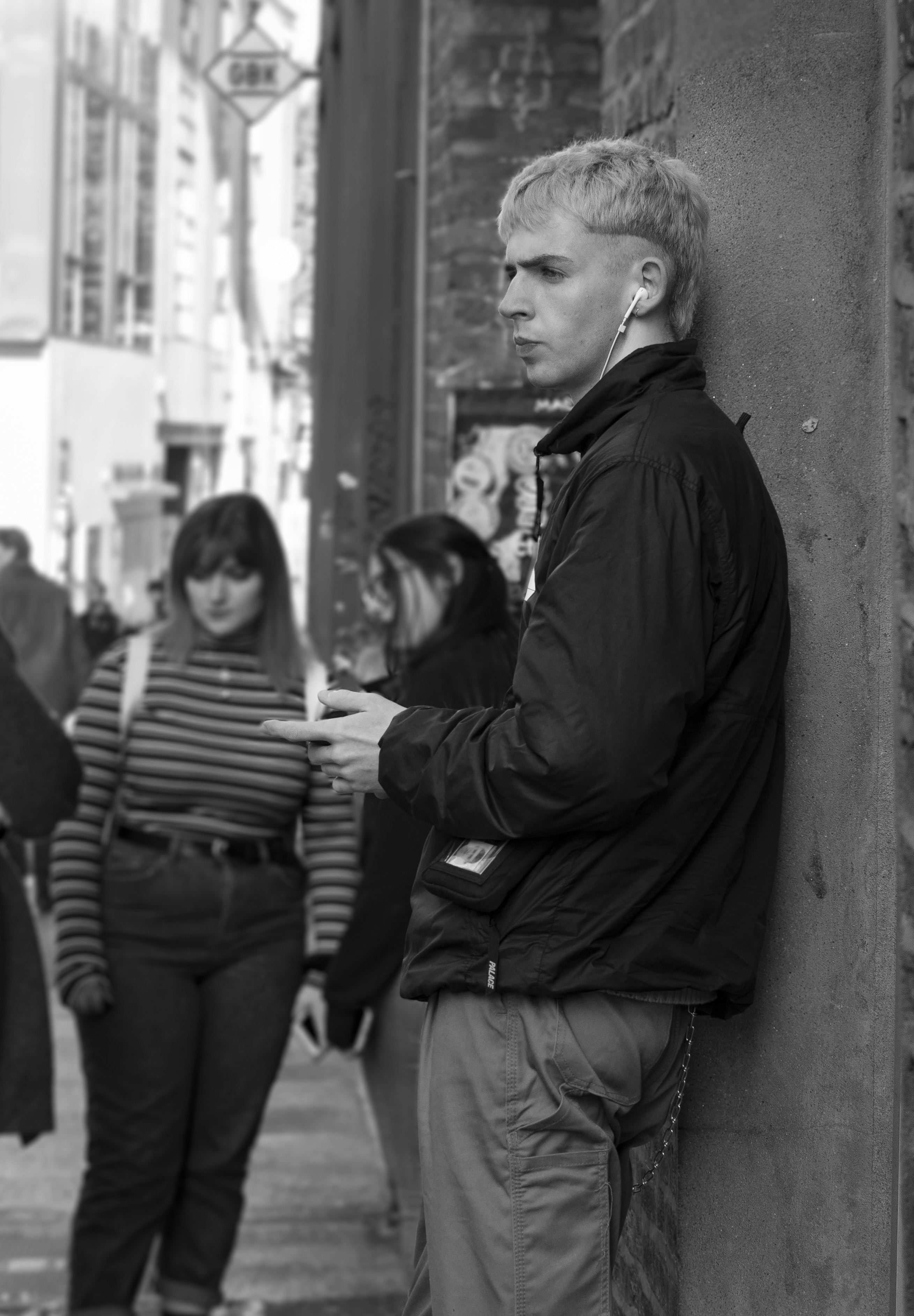 grayscale photography of people walking on pathway