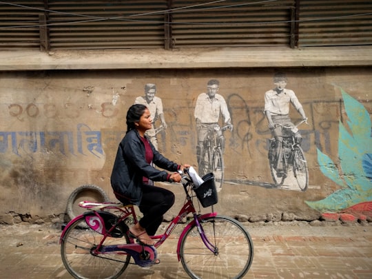 woman riding bike in Patan Nepal