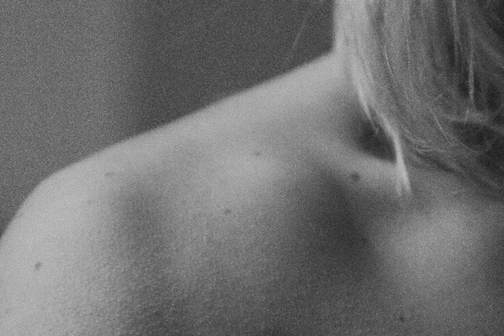 a black and white photo of a woman's back