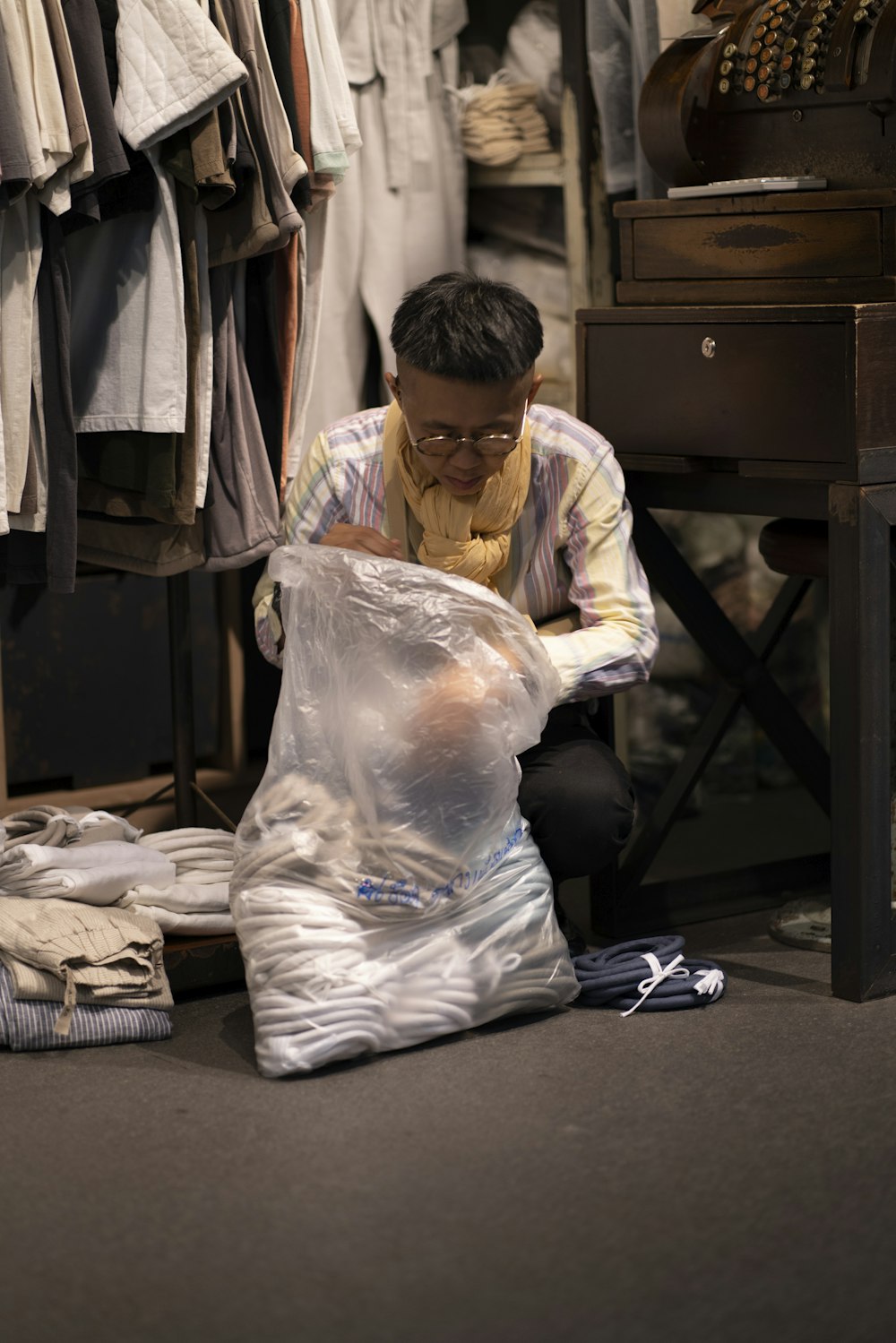 man putting clothes in sack