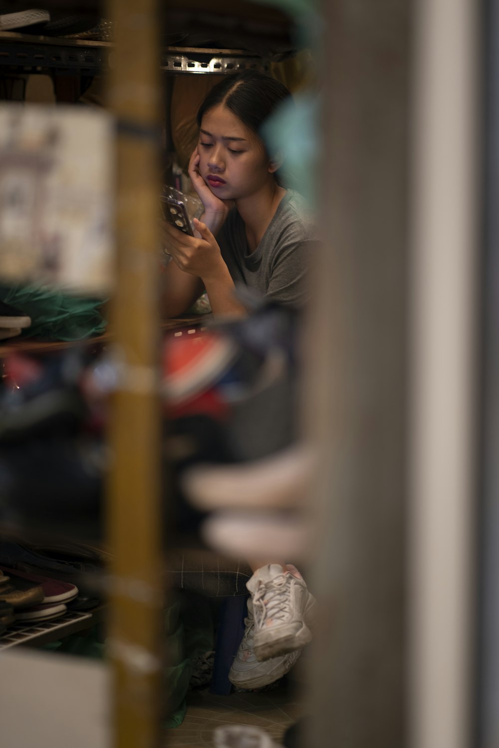 a woman sitting on the floor looking at her cell phone