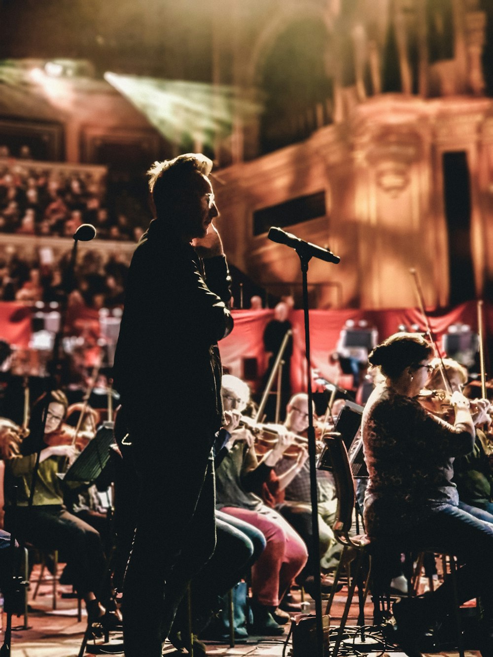 standing man beside choir